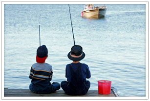 Two kids fishing off the pier